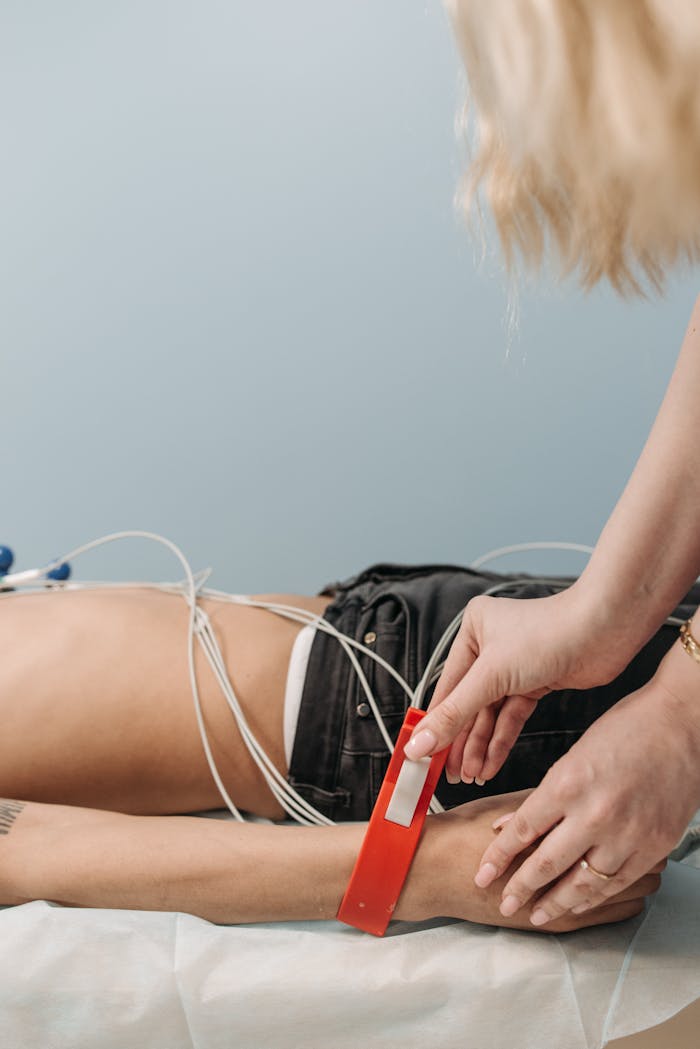 our-story A healthcare professional attaches ECG sensors to a patient in a clinic setting.