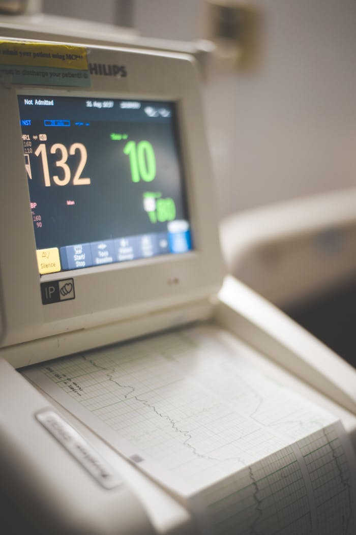 about-us Close-up view of an ECG monitor displaying patient vitals and printed graphs.